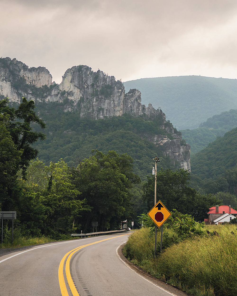 A road curving toward the rock fins of Seneca Rocks, West Virginia